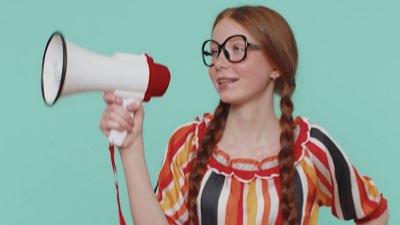 Girl in a colourful dress using a megaphone